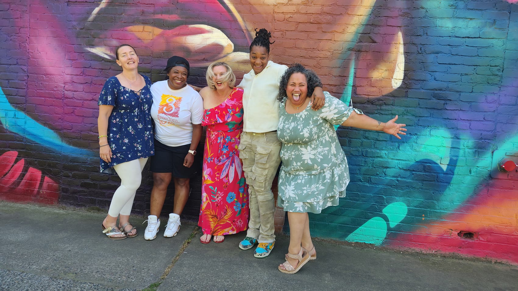 Connect 2 Change women together at a Sacramento mural